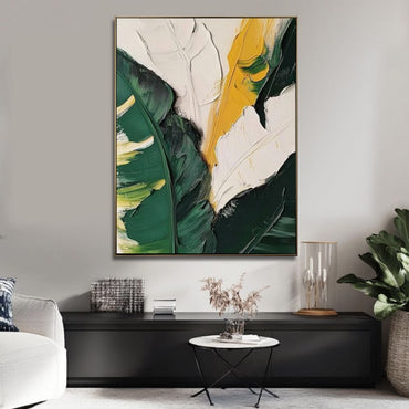 Abstract art piece with green and yellow leaves in a modern living room setting.