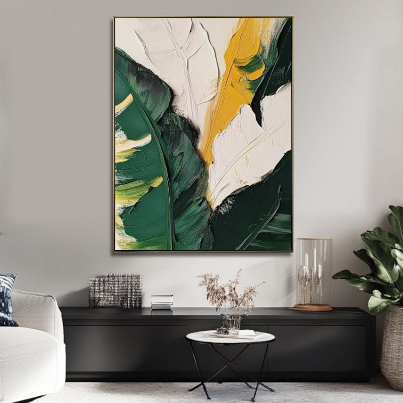 Abstract art piece with green and yellow leaves in a modern living room setting.