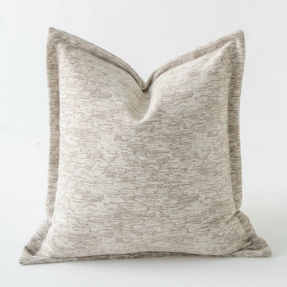 Textured beige pillow on a white background