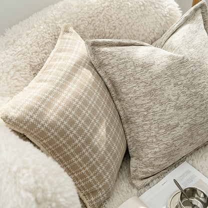 Close-up of textured pillows on a sofa with a magazine and bowl in the background.